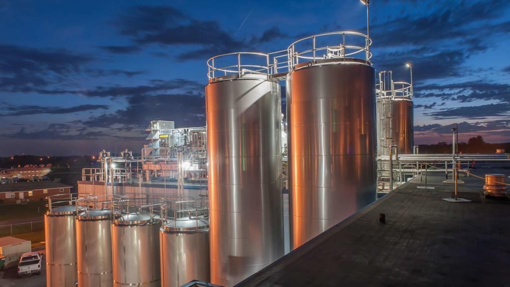 Dairy storage tanks at dusk.